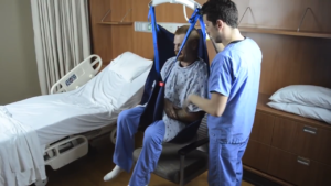 Transferring Patient from Chair to Bed with Seated Sling and Ceiling Lift